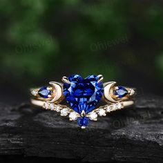 This is a lab sapphire engagement ring in solid gold,about 7mm 1.2ct heart shaped. The accent stones are lab sapphires and diamonds or moissanites. The matching band stones are lab sapphire and diamonds or moissanites. The band width about 1.4mm. It can be made in any ring size. However please contact me to custom make it to a special big or small size. It can be made in white gold,rose gold or yellow gold with 14k or 18k. However for some people who are nickel allergic,I can also make it to 925 Blue Stone Engagement Ring, Sapphire Rings Engagement, Sapphire Wedding Ring Set, Magic Academy, Heart Wedding Rings, Sapphire Engagement Ring Set, Blue Sapphire Engagement Ring, Shiny Rings, Saphir Ring