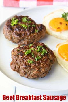 three breakfast sausage patties on a white plate with eggs and parsley in the background