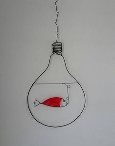 a light bulb with a red fish in it hanging from the ceiling and wires attached to the wall