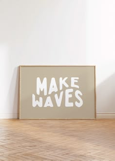 a wooden frame with the words make waves printed on it in white paint against a wall