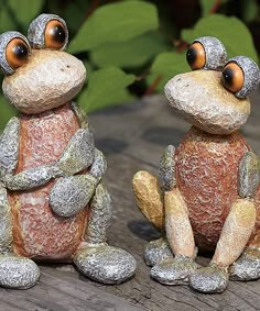 two frog figurines sitting next to each other