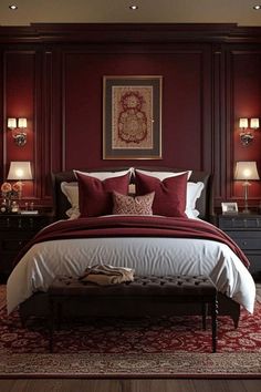 a bedroom with red walls and white bedding in the center, along with two lamps on either side of the bed