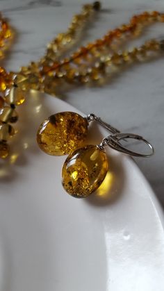 ❤ These beautiful drop earrings are made of genuine lemon or light green amber with 925 sterling silver details.  ❤ Such jewelry is always a perfect gift for every woman and for any occasion. Especially amber stones add luxury and romance to the whole style & make it look more exclusive, because every amber stone is unique. There are 3 different earrings: 1) light green - photos 1-4; diameters 1.7 x 1.4 cm (0.67 x0.55 inches) 2) lemon 1 - photos 5-7; diameters 1.5 x 1.3 cm (0.59 x 0.51 inches) 3 Amber Citrine Drop Earrings, Amber Citrine Teardrop Earrings, Amber Citrine Earrings With Ear Wire, Handmade Round Citrine Earrings, Yellow Oval Citrine Earrings, Handmade Baltic Amber Teardrop Jewelry, Handmade Amber Earrings For Anniversary, Yellow Baltic Amber Teardrop Jewelry, Yellow Round Sterling Silver Earrings