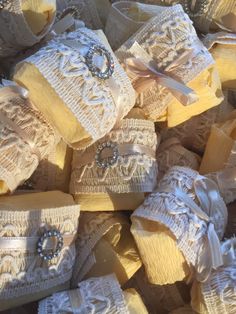 some yellow and white soaps are piled up on top of each other with bows