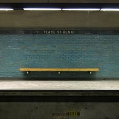 a bench sitting on the side of a train platform