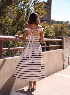 Step out in style with our unique Beverly Boulevard Dress. This midi dress features a zipper in the back for a perfect fit, while the tie off shoulder straps add a touch of elegance. The A-line silhouette provides a flattering shape, making this dress a must-have for any occasion. Fabric 100% polyester Spring A-line Midi Dress With Tie Straps, Chic A-line Maxi Dress With Tie Back, A-line Sundress With Tie Straps, Brunch Maxi Dress With Tie Back And Straight Neckline, Chic Off-shoulder Midi Dress, Brunch Dresses With Tie Straps And Straight Neckline, Dresses With Tie Straps And Straight Neckline For Brunch, Elegant Strapless Off-shoulder Dress For Day Out, Elegant Strapless Off-shoulder Dress