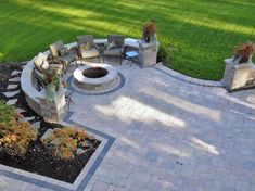 an outdoor patio with seating and fire pit