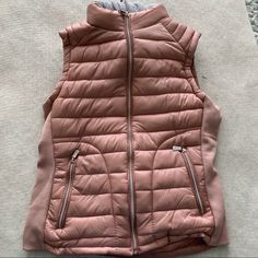 This Vest Is New Without Tags And Has Never Been Worn. All Zippers But One Still Have Protective Covering On Them. The Outside Is Ballet Pink, And There Is A Removable Gray, Knit Lining That Includes The Hood. This Is Attached By Zipper. The Inside Is A Soft Fleece Material In The Same Ballet Pink Color. There Are 2 Zipper Pockets On The Front. From Armpit To Waist Measures 13 Inches. The Size Is A Juniors Large. Hooded Puffer Vest, Ballet Pink, Puffer Vest, Pink Color, Zipper Pocket, Puffer, Jackets For Women, Jackets & Coats, Ballet