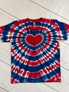 a red, white and blue tie - dye shirt with a heart on it