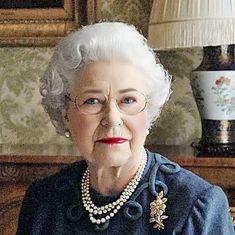 an old woman with glasses and pearls on her head sitting in front of a lamp