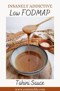 a spoon pouring liquid into a bowl filled with food