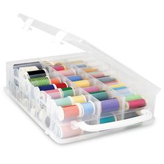 a clear box filled with lots of spools of thread