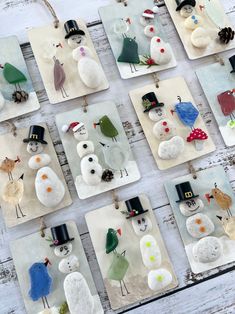 snowmen and birds are made from glass on coasters with acrylic paint