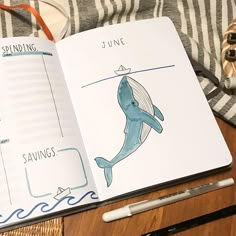 an open notebook with a drawing of a whale on it and the words saving written in blue ink