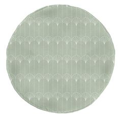 a round plate with an art deco design on the front and sides, in light green