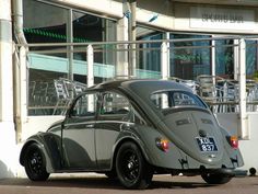 an old car parked in front of a building