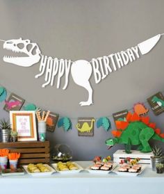 a dinosaur birthday party with food and decorations