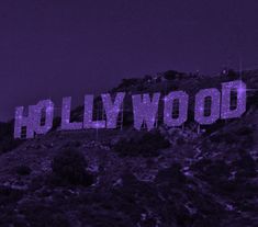 the hollywood sign is lit up in purple