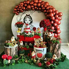 a table topped with lots of red and gold balloons