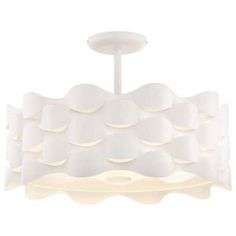 a white light fixture hanging from the ceiling with circles on it's sides,