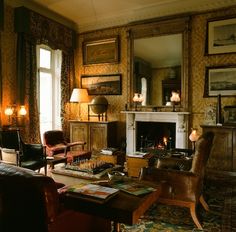 a living room filled with furniture and a fire place in the middle of a room