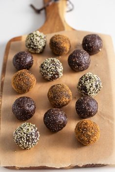 chocolate truffles are lined up on a cutting board and ready to be eaten