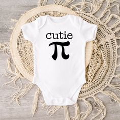 This cutie pi baby bodysuit brings out more fun on Pi Day. Crafted from 100% cotton interlock fabric, this sweet bodysuit features a reinforced three-snap closure on the binding and piped leg seams for a comfortable and snug fit. Soft and gentle on touch, it's also designed with lap shoulders for easy changing. The white color is sewn with 100% cotton thread, creating a classic heirloom look. Best of all, it's printed on a direct to garment printer with premium eco-based ink for safety and style Cute Cotton Onesie For Playtime, Cute Unisex Cotton Short Sleeve Bodysuit, Cute Unisex Cotton Onesie, Cute Cotton Short Sleeve Bodysuit For Playtime, Cute Onesie With Letter Print For Playtime, Playful Cotton Onesie For First Birthday, Cute Letter Print Onesie For Playtime, Cute Short Sleeve White Cotton Bodysuit, Cute White Cotton Short Sleeve Bodysuit