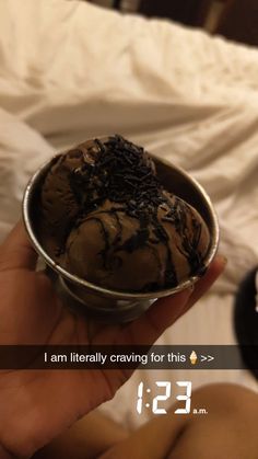 someone is holding up a bowl of ice cream with chocolate toppings on it and the text reads, i am literally craving for this