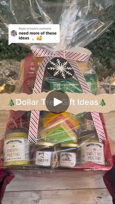 a basket filled with lots of food on top of a wooden table next to a christmas tree