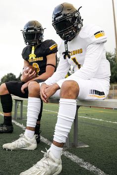 two football players are sitting on the bench