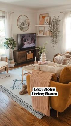 a living room filled with furniture and a flat screen tv sitting on top of a wooden table