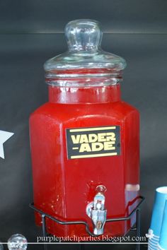 a red beverage dispenser sitting on top of a table