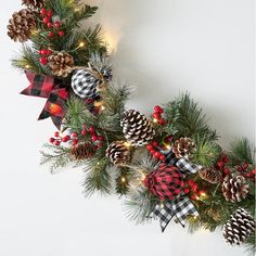 a christmas wreath with pine cones and lights