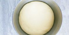 a ball of dough in a saucepan on a counter