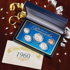 the commemorative coin set is in its box and it's next to some confetti