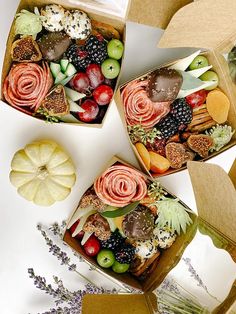 three boxes filled with assorted fruits and veggies on top of a table