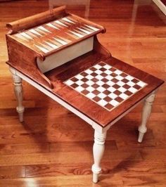 a small table with a chess board on it and some drawers in the top half