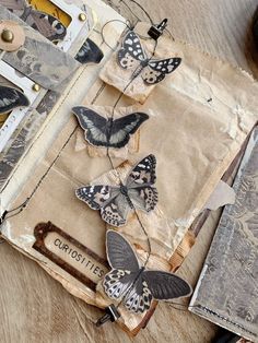 some butterflies are sitting on top of an old piece of paper that has been altered