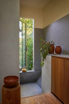 a bathroom with a tub and wooden floors