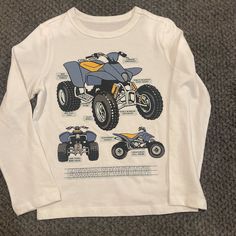 White Graphic Tshirt With 4 Wheelers In Blue And Some Yellow, The Shirt Is Long Sleeve, Organically Grown Cotton, The Brand Is Gap Kids, Size Is Xs Which Equivalent To A Size 4-5 In Boys. Gap Blue Graphic Print Top, Gap White Graphic Print T-shirt, White Gap T-shirt With Graphic Print, Blue Graphic Print Tops From Gap, Blue Graphic Print Gap Tops, Gap White Graphic Tee T-shirt, White Graphic Tee By Gap, White Gap Graphic Tee, Gap Long Sleeve Top With Letter Print