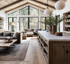 a living room filled with furniture and lots of windows