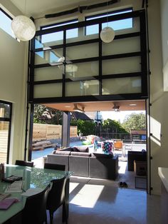 an open living room and dining area with sliding glass doors