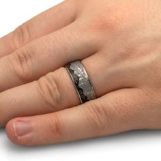 a person's hand with a wedding ring on it