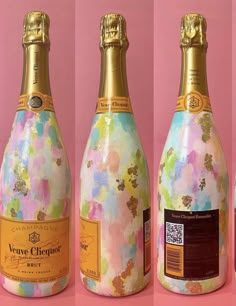 three bottles of champagne with different patterns and designs on them, one has a gold cap