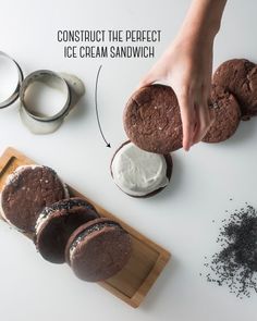 an image of someone making ice cream sandwiches with chocolate cookies and whipped cream on the side