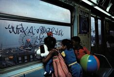 two children sitting on a train looking out the window