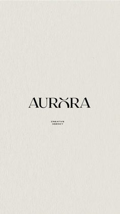 the word aurora is written in black ink on a white paper with an elegant font