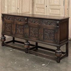 an old wooden sideboard with carvings on it