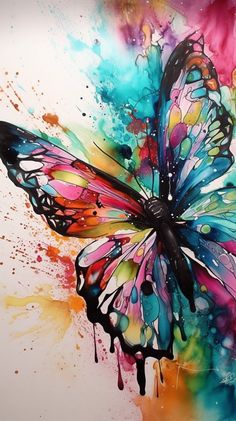 a colorful butterfly painted on top of a white wall with lots of paint splattered all over it