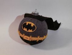 a knitted batman ornament hanging from a string